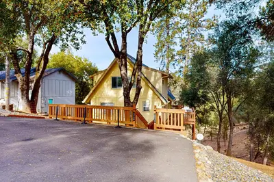 a house with a wooden deck on a driveway at Serendipity in Groveland