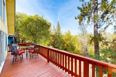 a wooden deck with a table and chairs on it at Serendipity in Groveland