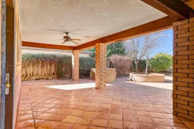 a patio with a ceiling fan and a brick wall at Happy Hours - Beautiful Quiet Comfortable Suite #3 in Visalia