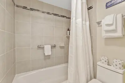 a bathroom with a shower curtain and a toilet at Lakeland Studio - Walk to Casinos, Restaurants And Gondola in South Lake Tahoe