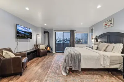 a bedroom with a large bed and a tv at Lakeland Studio - Walk to Casinos, Restaurants And Gondola in South Lake Tahoe