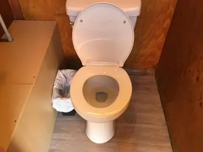 a bathroom with a toilet in a box at Big Glamping Teepee in Bodfish