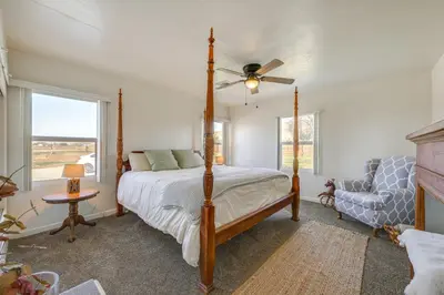 a bedroom with a bed and a fan and a chair at 19 Mi to Sequoia Natl Park Mtn-View Woodlake Gem in Woodlake