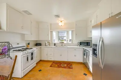 a kitchen with white cabinets and a stainless steel refrigerator at 19 Mi to Sequoia Natl Park Mtn-View Woodlake Gem in Woodlake