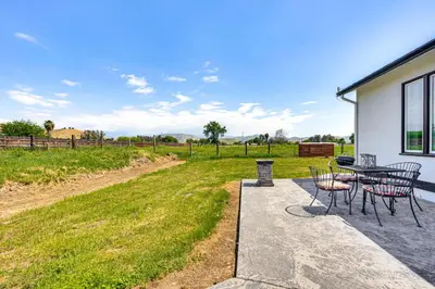 a patio with a table and chairs and a field at 19 Mi to Sequoia Natl Park Mtn-View Woodlake Gem in Woodlake