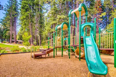 a playground with a slide in a park at The Cozy Condo in Kingswood Estates