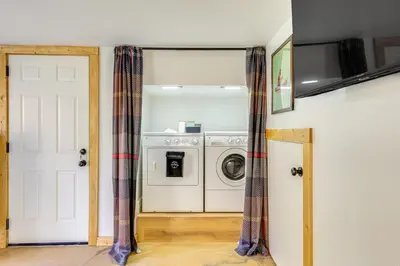 a laundry room with a washer and dryer at Walk to Golf, Lake Twain Harte Cabin with Fireplace in Twain Harte