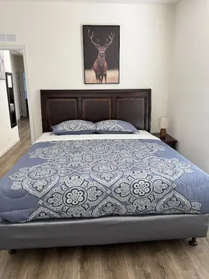 a bedroom with a bed with a deer on the wall at Brand New Scenic Sequoia House in Three Rivers
