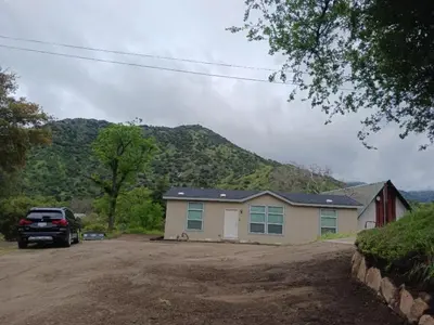 a house with a car parked in front of it at Brand New Scenic Sequoia House in Three Rivers
