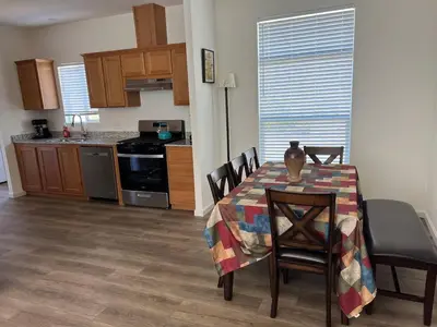 a kitchen and dining room with a table and chairs at Brand New Scenic Sequoia House in Three Rivers