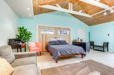 a bedroom with a bed and a couch and a tv at Drive to Major Parks Nature Getaway in West Point in West Point