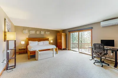 a bedroom with a bed and a desk with a computer at Cliffside Retreat in Zephyr Cove