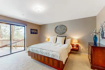 a bedroom with a large bed and a balcony at Cliffside Retreat in Zephyr Cove