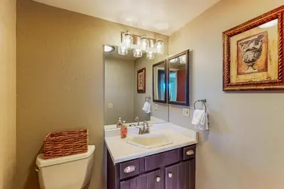 a bathroom with a sink and a toilet and a mirror at Cliffside Retreat in Zephyr Cove
