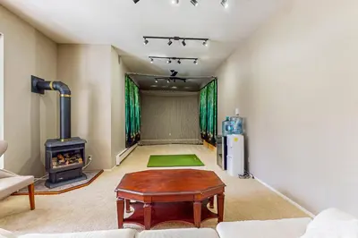 a living room with a wood stove and a table at Cliffside Retreat in Zephyr Cove