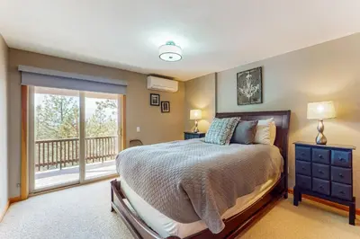 a bedroom with a bed and a balcony at Cliffside Retreat in Zephyr Cove