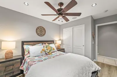 a bedroom with a bed with a ceiling fan at Casita Andrade in Turlock