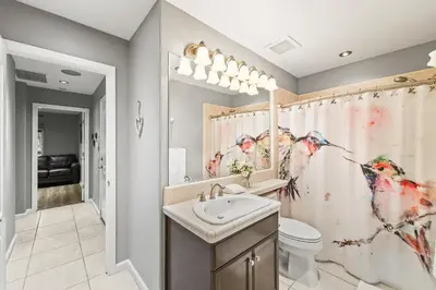 a bathroom with a shower curtain with birds on it at Casita Andrade in Turlock