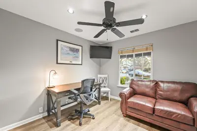 a living room with a couch and a desk and a ceiling fan at Casita Andrade in Turlock