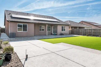 a house with a lawn in front of it at Spacious 4BR Home With BBQ, Near Sequoia & Fresno in Hanford