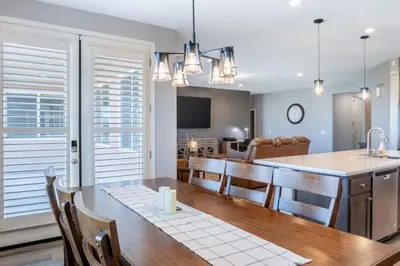 a kitchen and dining room with a table and chairs at Spacious 4BR Home With BBQ, Near Sequoia & Fresno in Hanford