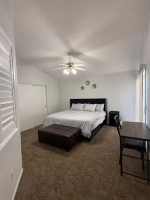 a bedroom with a bed and a ceiling fan at Luxury Escape in Stockton