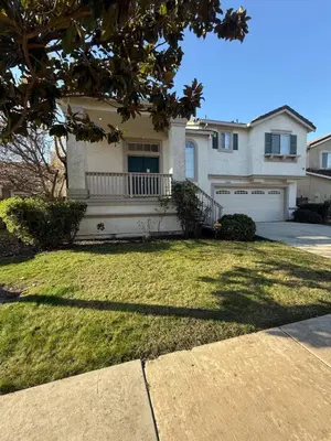 a large house with a yard with a driveway at Luxury Escape in Stockton
