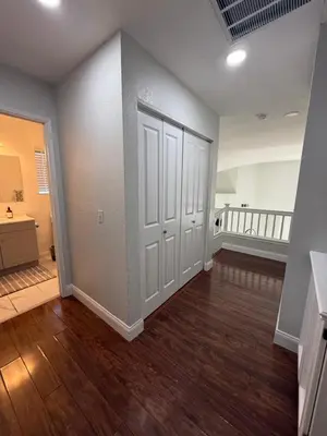 an empty room with white doors and wood floors at Luxury Escape in Stockton