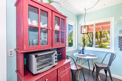 a kitchen with a red cabinet with a microwave at Sierra Vista Lookout Lodge for 8 people with Hot tub, deck and trail to waterfalls in North Fork