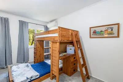 a bunk bed and a desk in a room at Sierra Vista Lookout Lodge for 8 people with Hot tub, deck and trail to waterfalls in North Fork