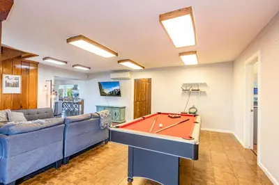 a living room with a couch and a pool table at Sierra Vista Lookout Lodge for 8 people with Hot tub, deck and trail to waterfalls in North Fork