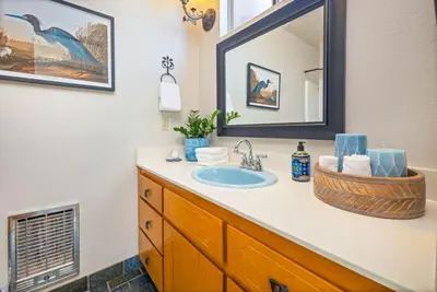 a bathroom with a sink and a mirror at 10-acre Forest Villa, 20 miles from Yosemite South in Oakhurst
