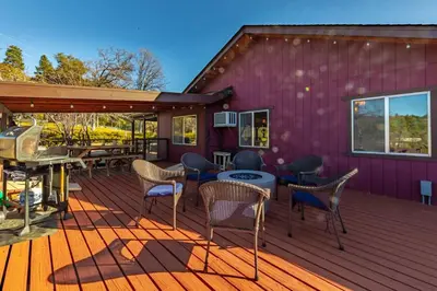 a purple deck with chairs and a grill at 10-acre Forest Villa, Single Floor, Hot tub, Patio in Oakhurst