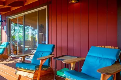 a group of chairs and tables on a porch at 10-acre Forest Villa, Single Floor, Hot tub, Patio in Oakhurst
