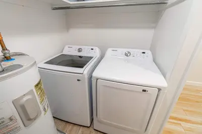 a small laundry room with a washer and dryer at Emerald Escape - UNR & Pet Friendly in Reno