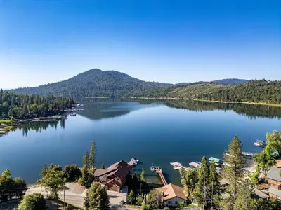 an aerial view of a lake with mountains in the background at Falls Lake View Winter Special Ends512 in Bass Lake