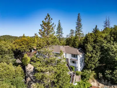 an aerial view of a house in the woods at Falls Lake View Winter Special Ends512 in Bass Lake