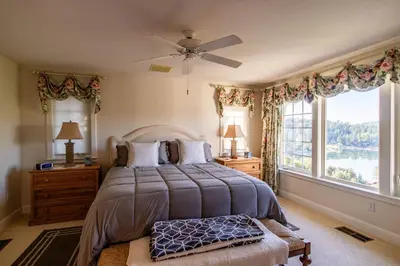 a bedroom with a bed and a large window at Falls Lake View Winter Special Ends512 in Bass Lake