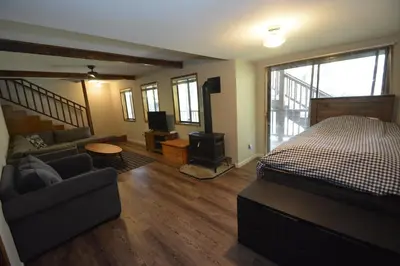 a bedroom with a bed and a couch and a television at SunRidge at Willow Cove Free Night Special in Bass Lake