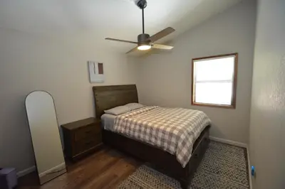 a bedroom with a bed and a ceiling fan at SunRidge at Willow Cove Free Night Special in Bass Lake