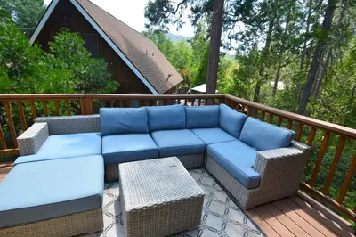 a blue couch sitting on a wooden deck at SunRidge at Willow Cove Free Night Special in Bass Lake