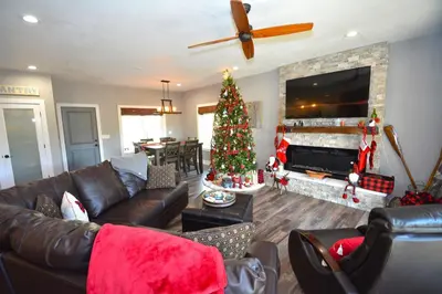 a living room with a christmas tree in front of a fireplace at Ledge House-Lake Area Free Night Special in Bass Lake