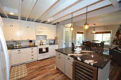 a kitchen with white cabinets and a christmas tree in it at Ledge House-Lake Area Free Night Special in Bass Lake