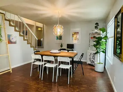 a dining room with a wooden table and chairs at Artist's Condo with 2 Bedroom & Arcade in Sacramento