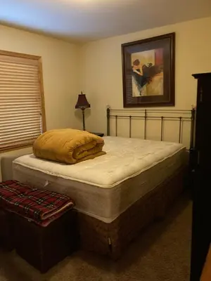 a large bed in a bedroom with a bed frame at Cozy 3 bedroom home in Tahoe Donner in Truckee