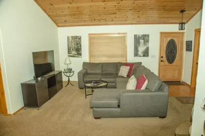 a living room with a couch and a television at Cozy 3 bedroom home in Tahoe Donner in Truckee
