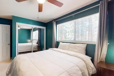 a bedroom with a large bed and a window at Wildwood Wonder in South Lake Tahoe