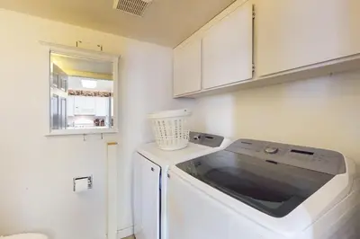 a small kitchen with a washer and dryer at Wildwood Wonder in South Lake Tahoe