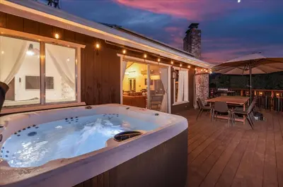 a jacuzzi tub in a house with a patio at Yosemite Lookout Lodge w/ hot tub, firepits, game room, and more in Oakhurst