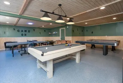 a ping pong room with two tables and two pool tables at Yosemite Lookout Lodge w/ hot tub, firepits, game room, and more in Oakhurst